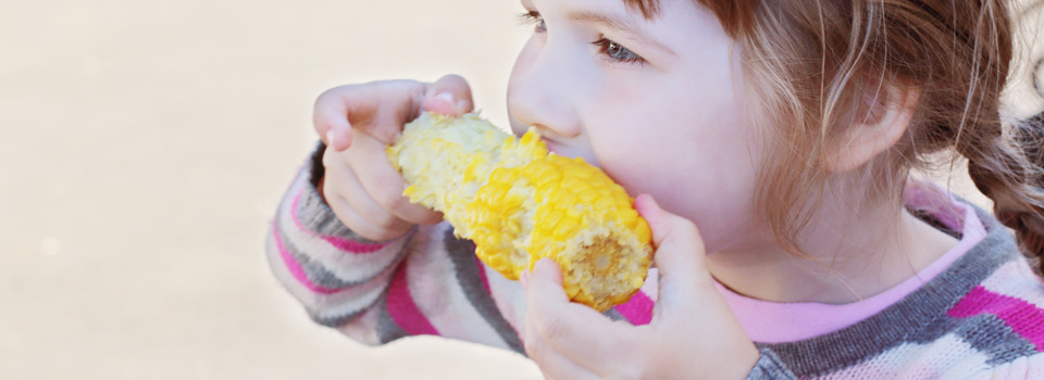 girl eating corn